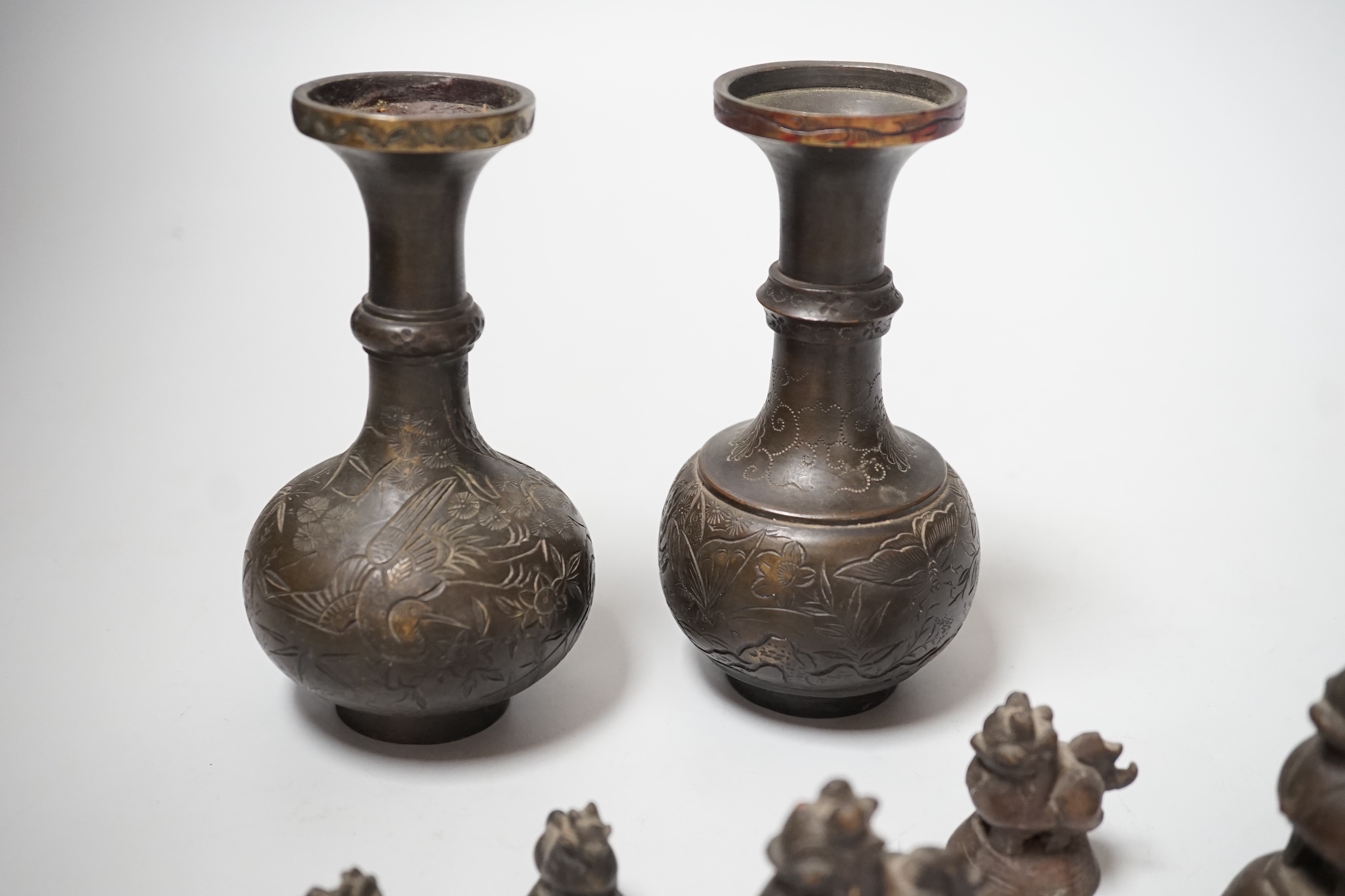 A set of Burmese bronze weights and a pair of bronze vases, 12cm